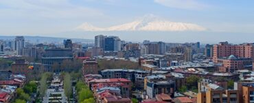 Yerevan cityscape at dusk from Cascade with Mount Ararat in background, Armenia