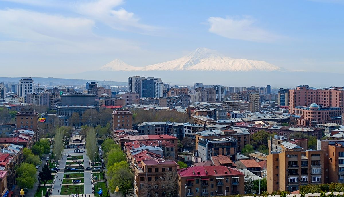 Yerevan cityscape at dusk from Cascade with Mount Ararat in background, Armenia